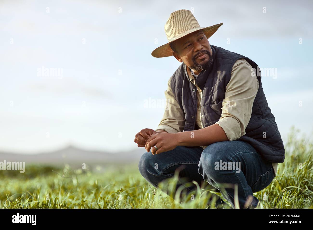 Theres patience and then theres farmer patience. Shot of a mature man working on a farm. Stock Photo