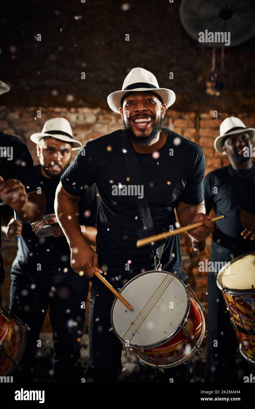 Their beats will keep you dancing all night long. Portrait of a group of musical performers playing drums together. Stock Photo