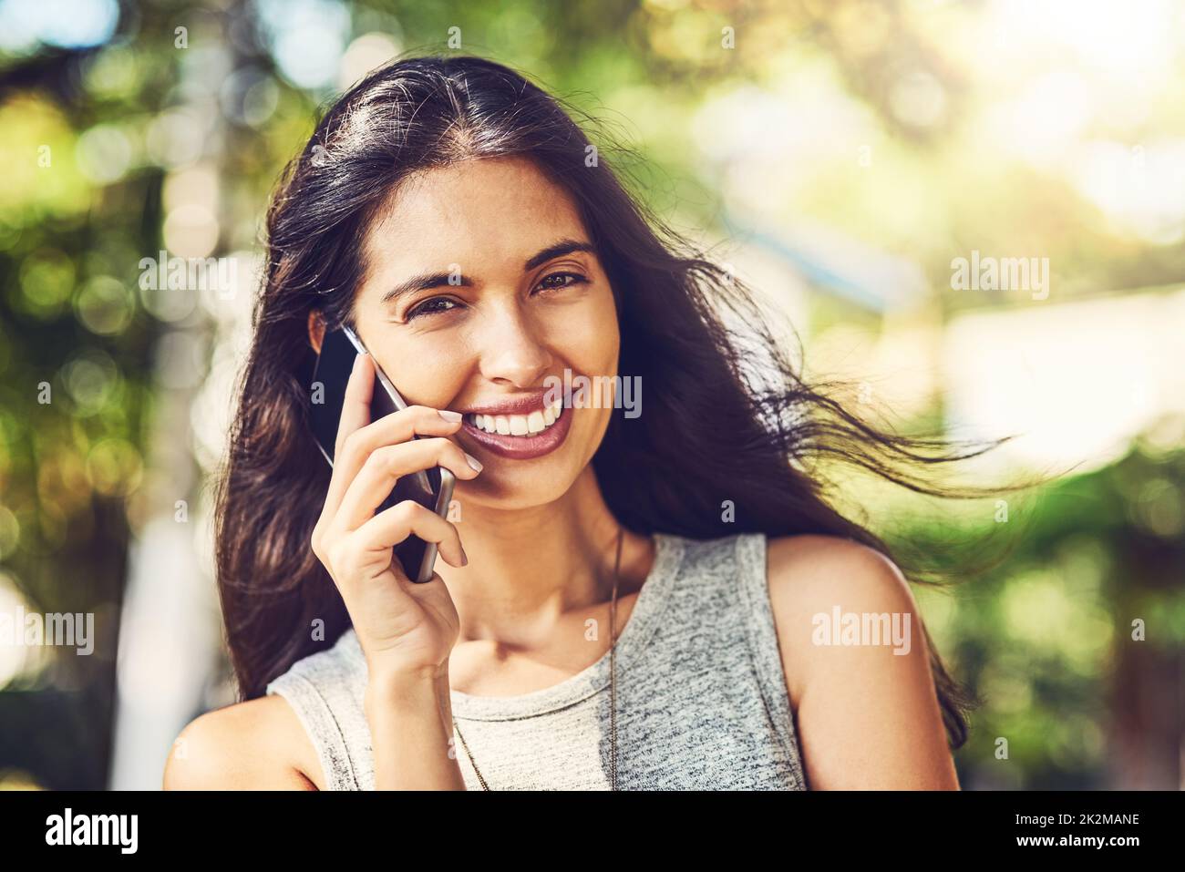 I cant survive without my connections. Portrait of an attractive young woman talking on a cellphone outdoors. Stock Photo