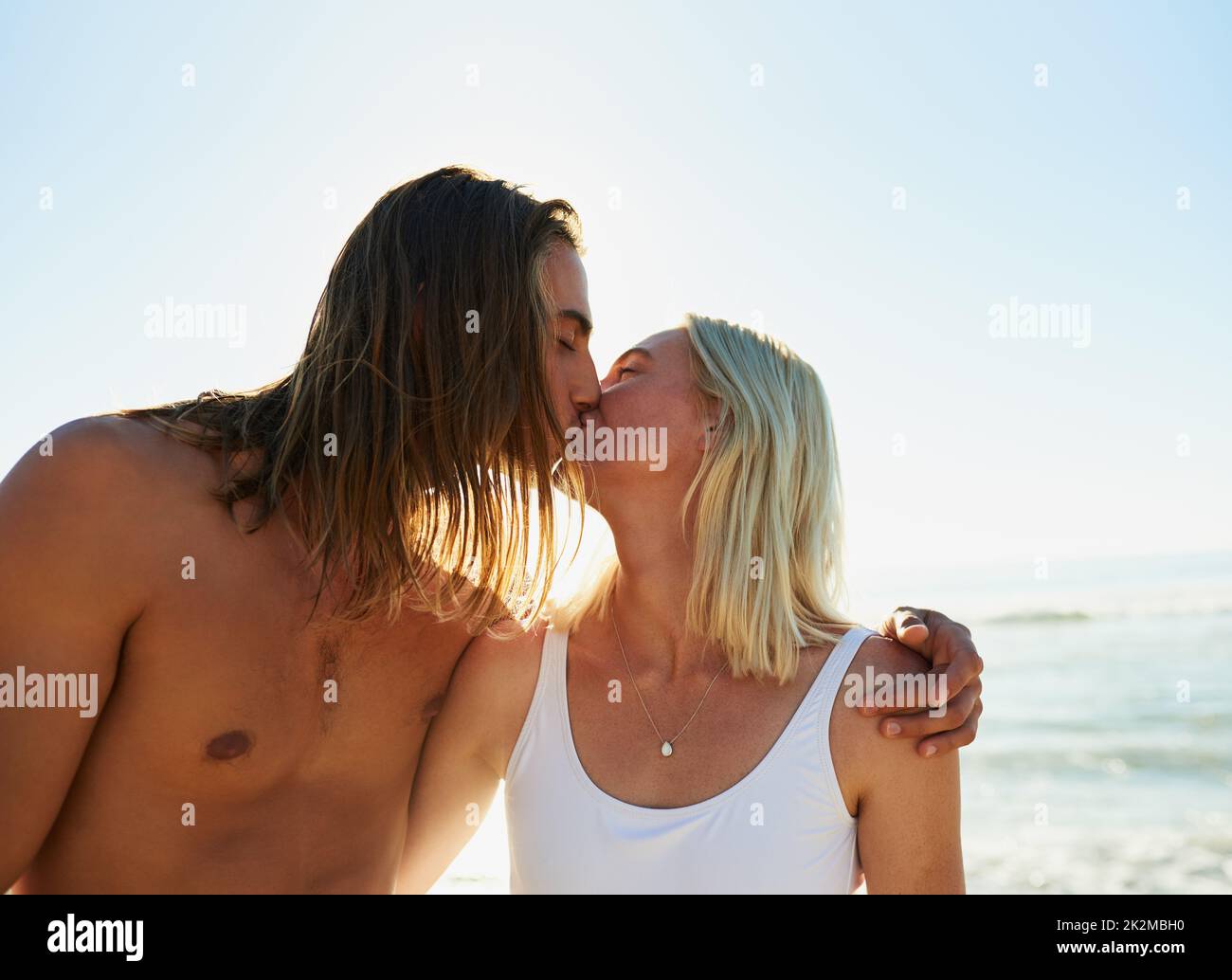 To truly love is to truly live. Shot of an affectionate young couple kissing each other at the beach. Stock Photo