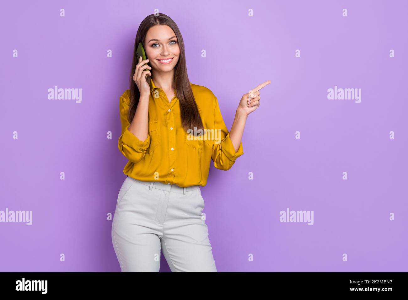 Photo of nice millennial lady say telephone index promo wear shirt isolated on purple color background Stock Photo