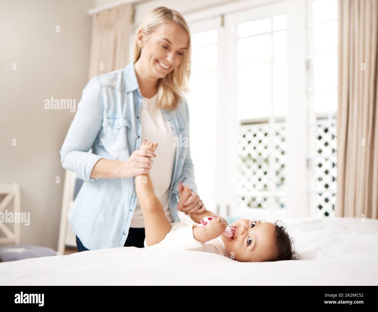 Its a new day, time to make new memories. Shot of a woman bonding with her baby at home. Stock Photo