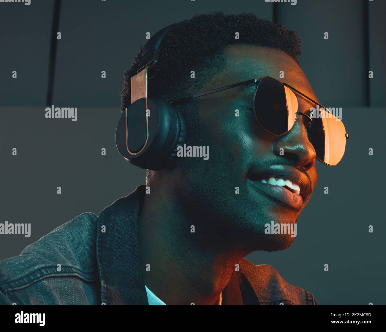 Im always in a mood, a good one. Studio shot of a man wearing headphones and sunglasses. Stock Photo