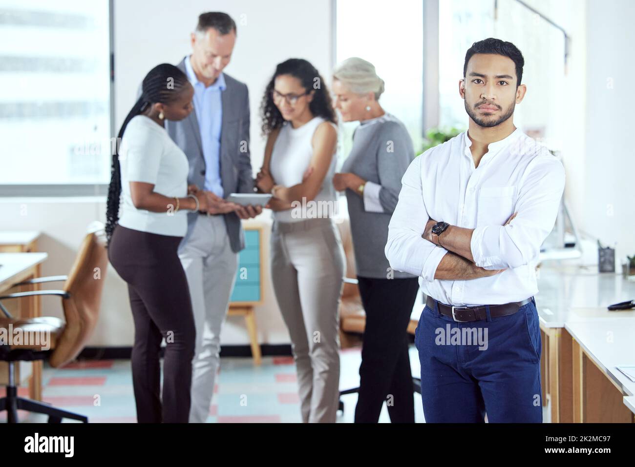 Lets get serious. Shot of a group of businesspeople standing in an office at work Stock Photo