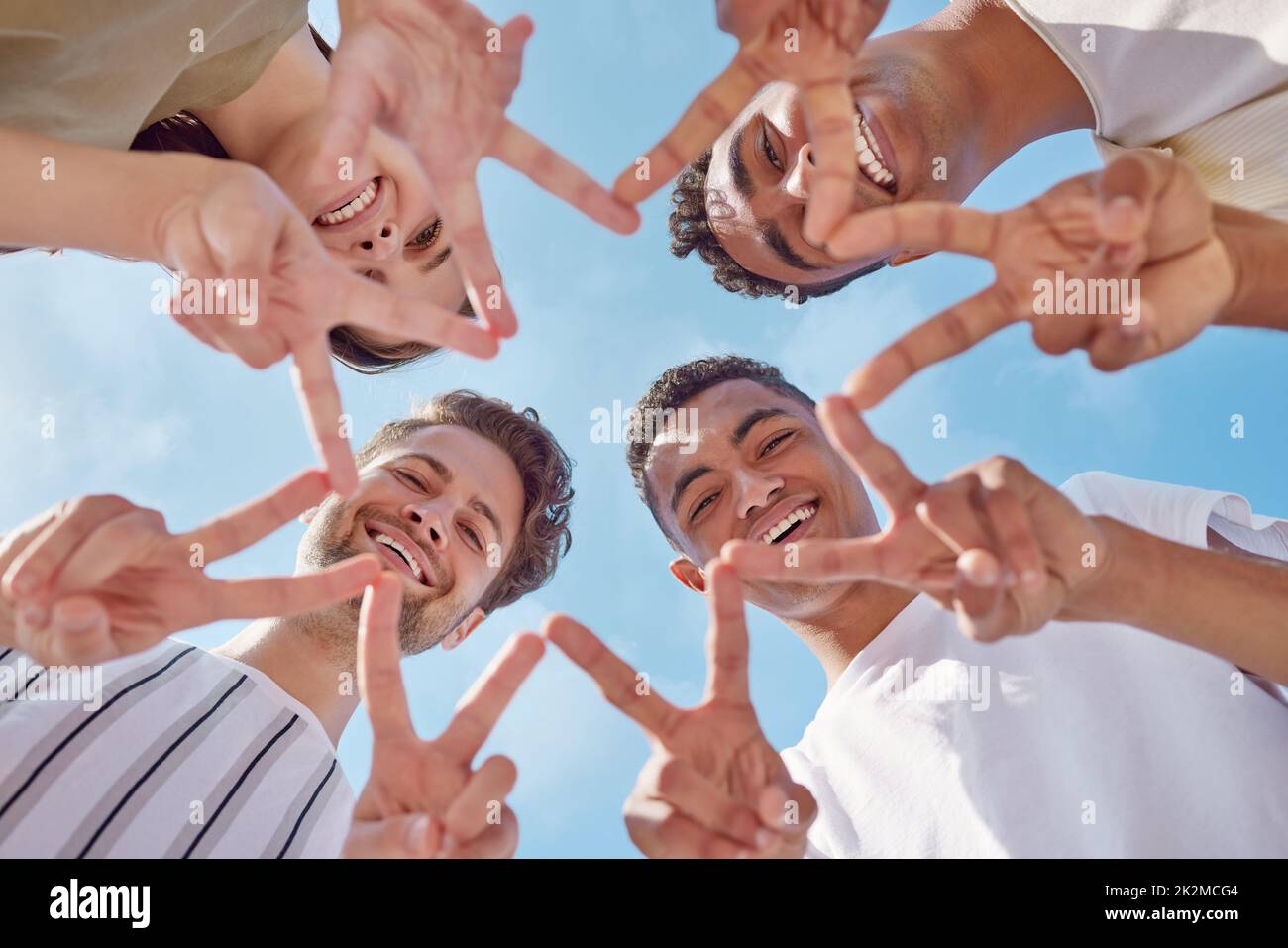 You shine brighter than a star. Shot of a group of young friends making a star shape with their hands outside. Stock Photo