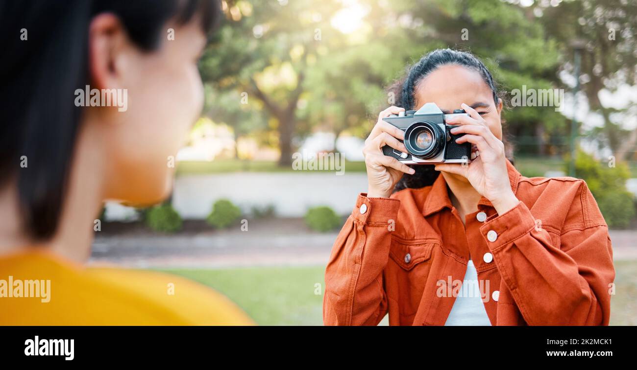 Its the friends you can call up at 4 a.m. that matter. Shot of a female taking photos of her friend outside. Stock Photo