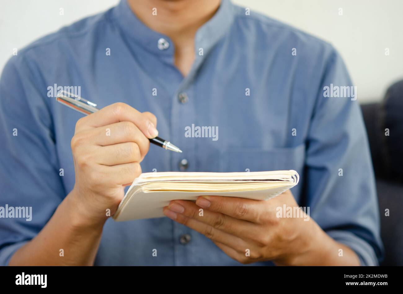 Businessman holding a pen and a notebook to take notes and plan ideas. Stock Photo