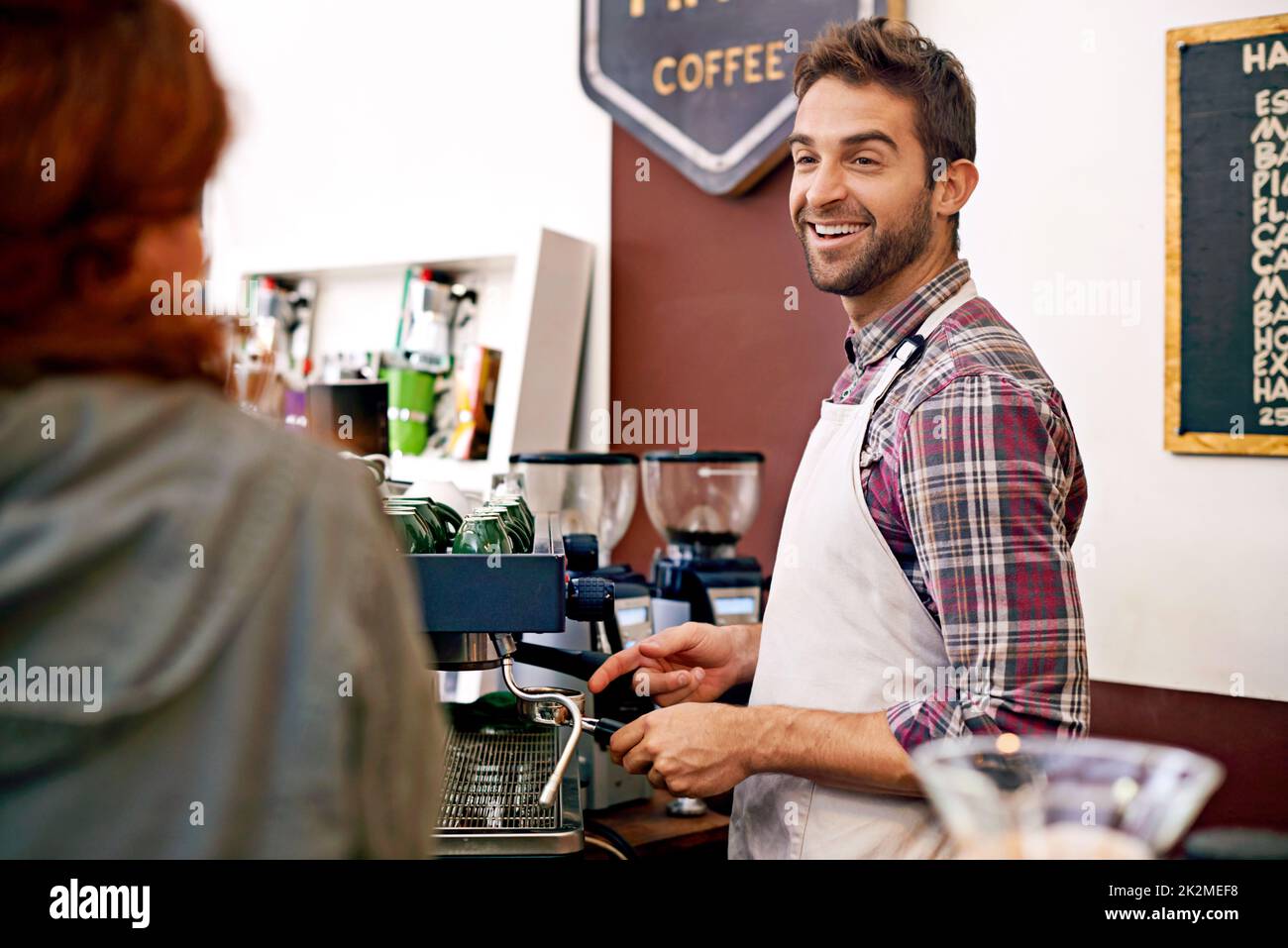 Service with smile. Shot of a young woman ordering coffee in a cafe. Stock Photo