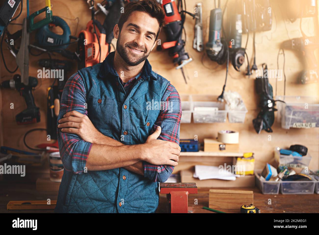 All the toys a man could ask for. Portrait of a man standing in his workshop. Stock Photo