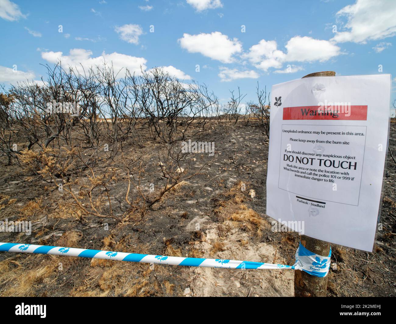 Warning of unexploded WW2 ordnance after some was found on heathland badly burnt by a major fire, Studland Heath, Isle of Purbeck, August 2022. Stock Photo