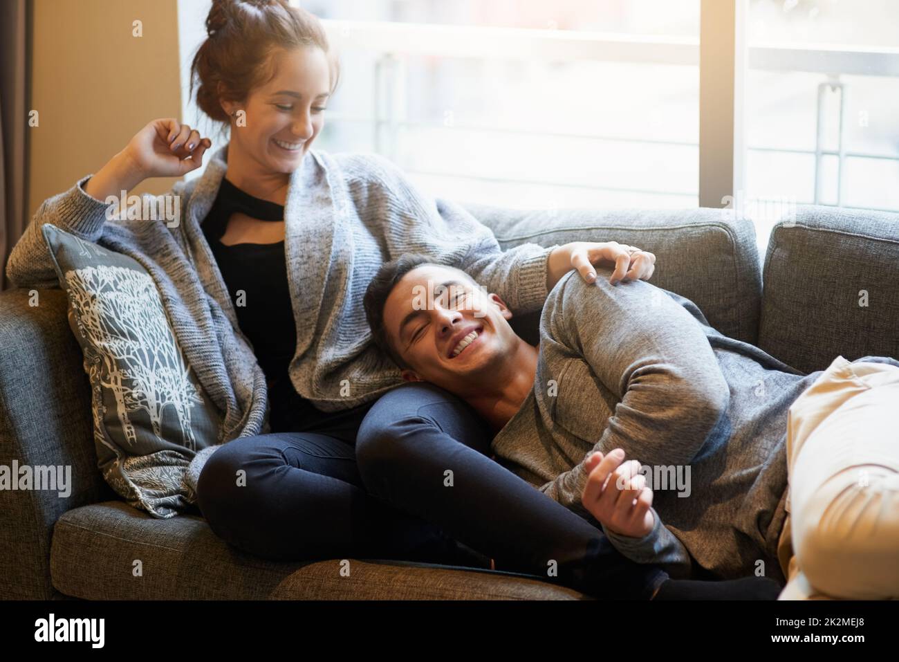The lap of love. Portrait of a handsome young man lying on his girlfriends lap on the sofa. Stock Photo