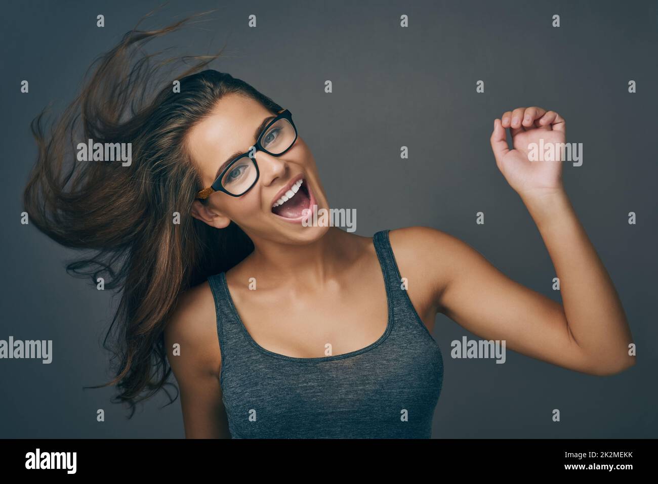 https://c8.alamy.com/comp/2K2MEKK/let-go-and-be-who-you-are-studio-shot-of-an-attractive-young-woman-wearing-glasses-2K2MEKK.jpg