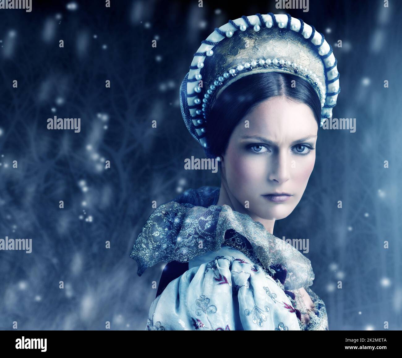 Dont let her gaze fall upon you. Portrait of a evil-looking queen with snow falling around her. Stock Photo