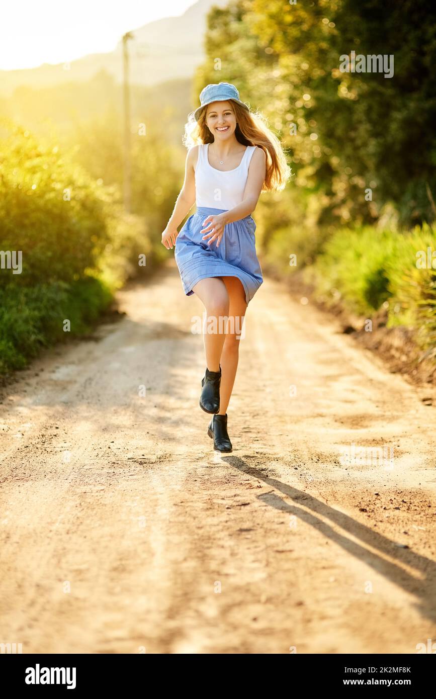 Nature improves your vitality. Shot of a young woman on a tree stump out in the countryside. Stock Photo