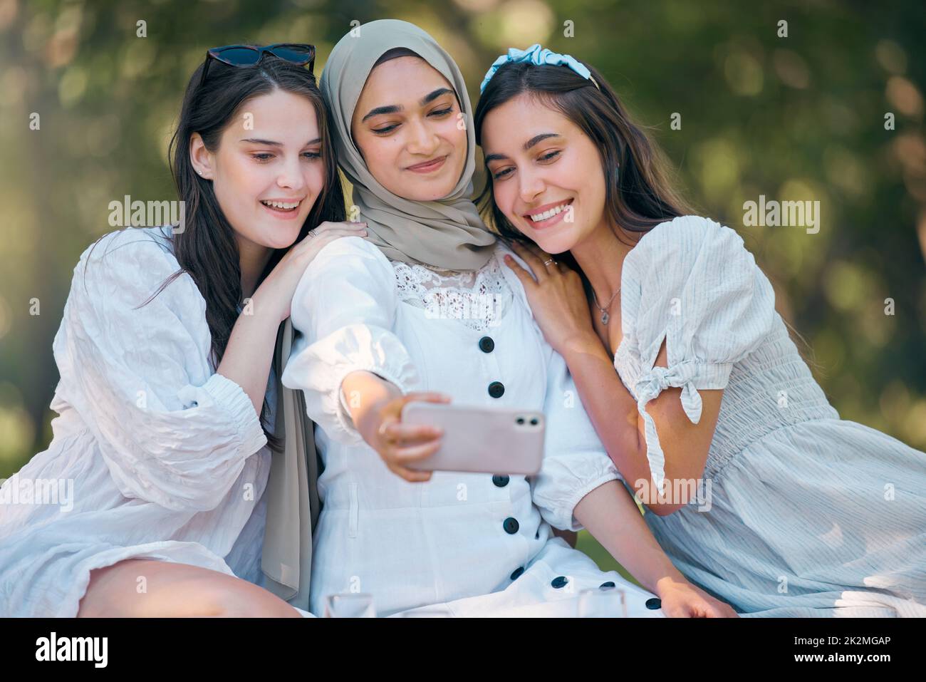 Diversity group of women, friends and selfie in park, garden and outdoor picnic together. Happy, smile and multicultural woman community taking phone Stock Photo