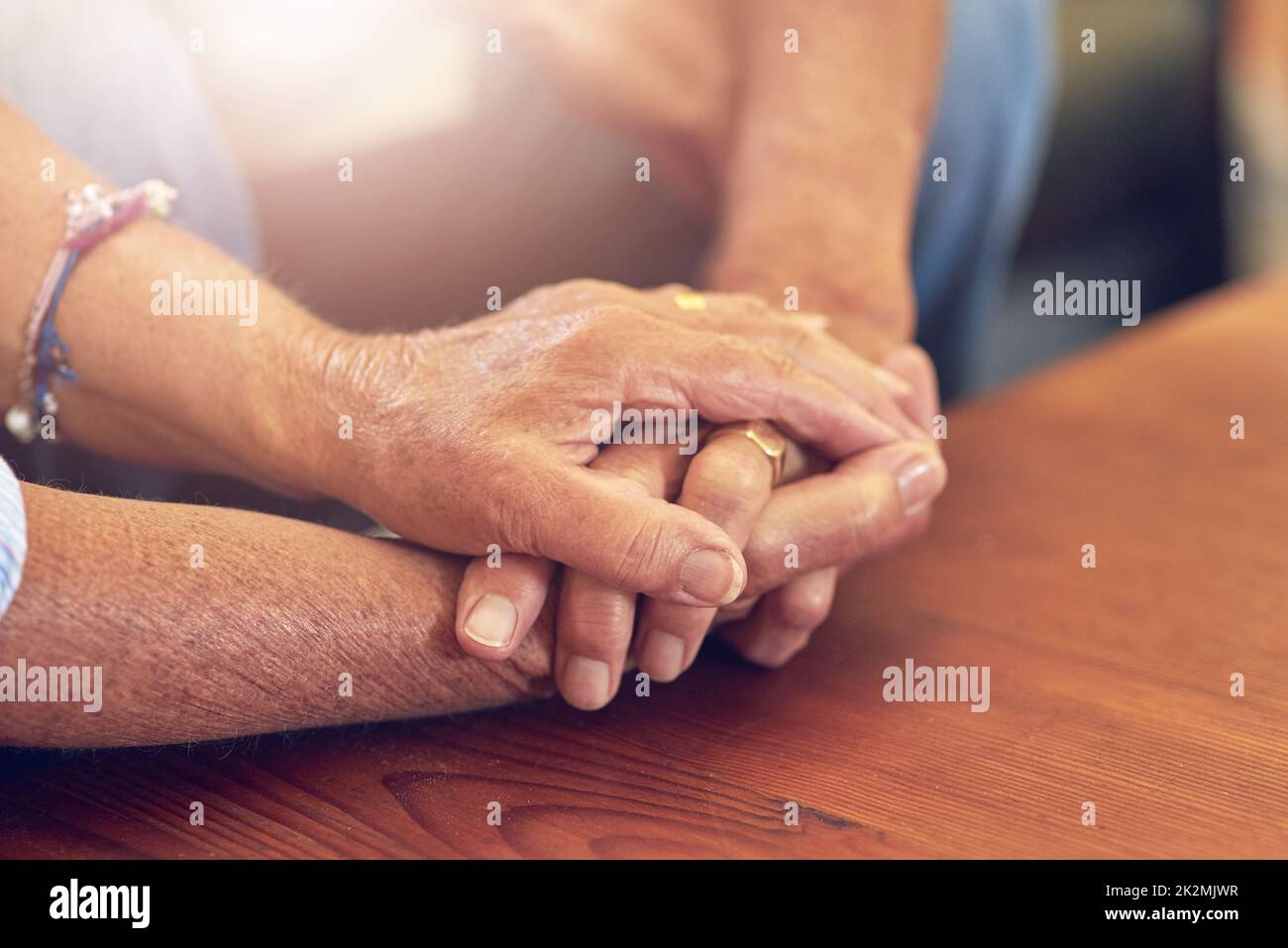 Life is precious. Take care of one another. Cropped shot of a senior man and woman holding hands in comfort. Stock Photo