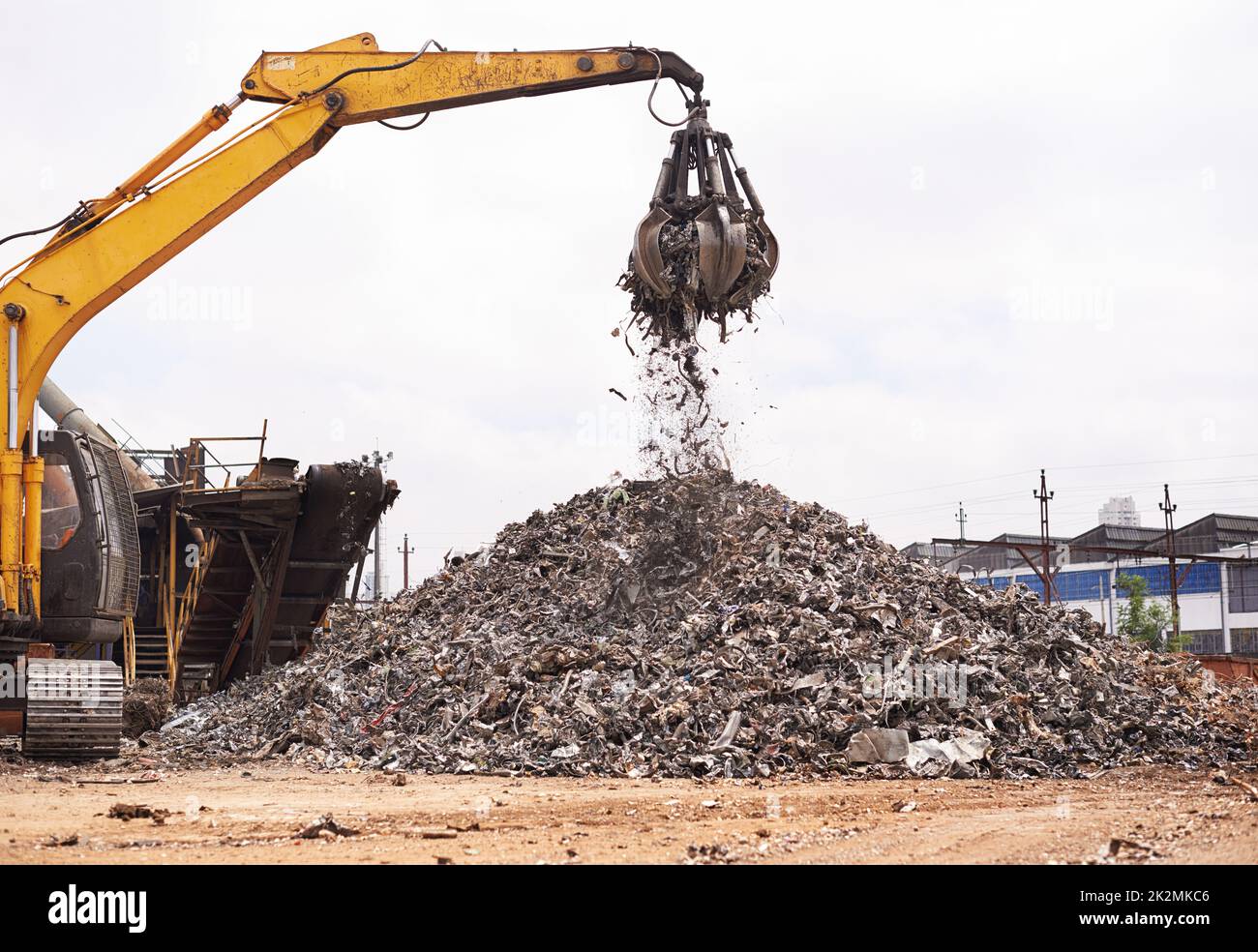 Industrial re-purposing. Cropped shot of an excavator sorting through a pile of scrap metal. Stock Photo
