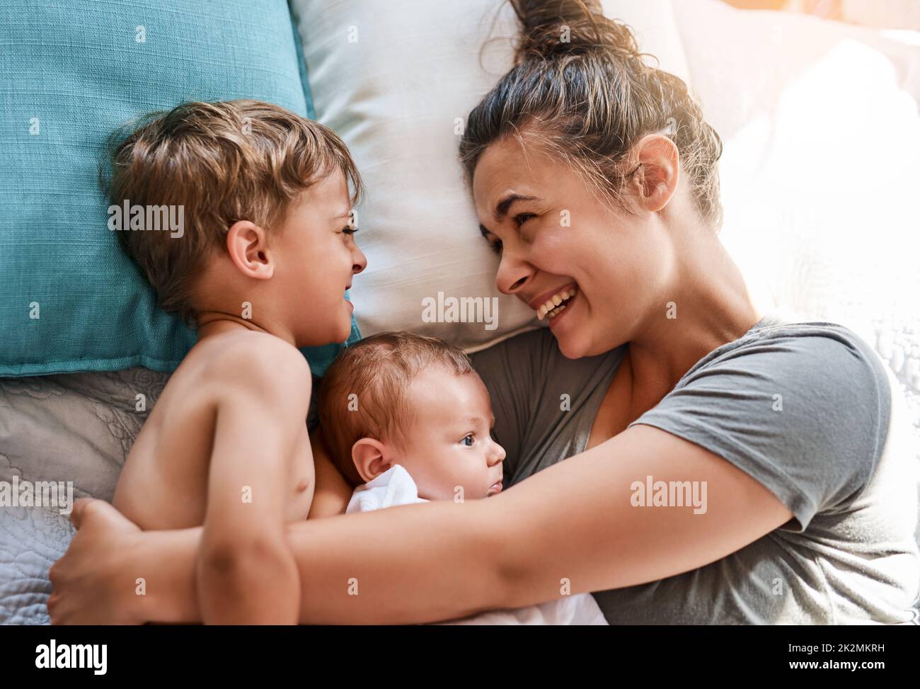 Her boys fill her life with joy. Shot of a young woman bonding with her two sons at home. Stock Photo