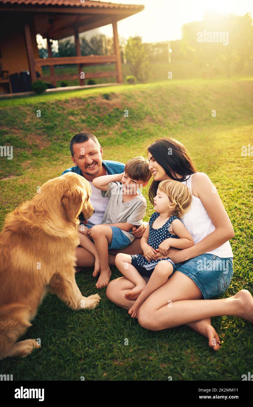 Its time for some backyard bonding. Shot of a young family spending the day in the backyard. Stock Photo