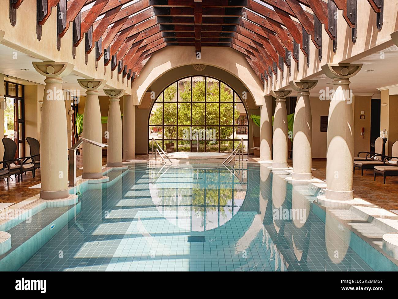 What a perfectly placid pool. Shot of an indoor swimming pool at a health spa. Stock Photo
