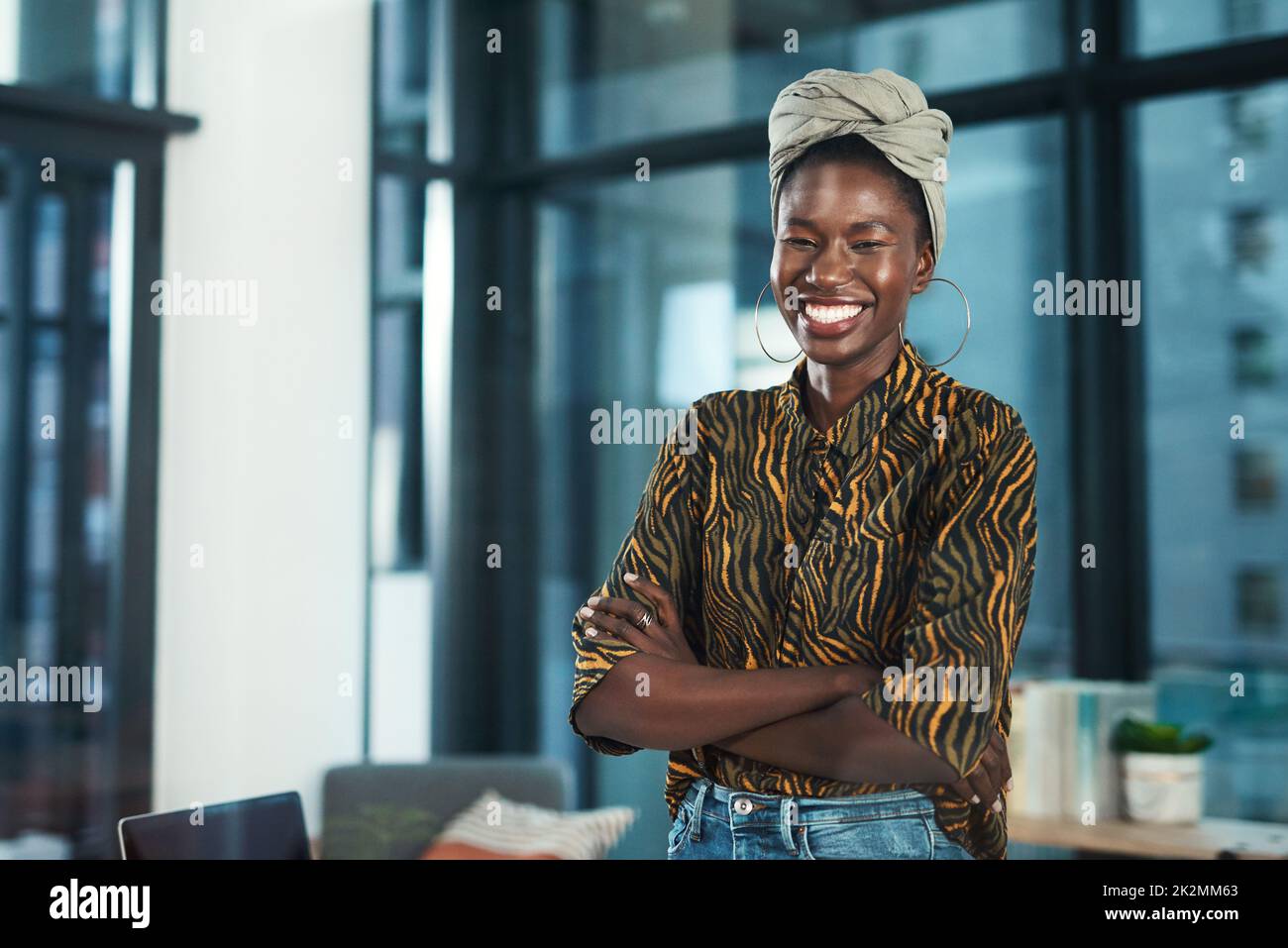 I never back down from challenges. Cropped portrait of an attractive young businesswoman standing alone in her office with her arms folded. Stock Photo
