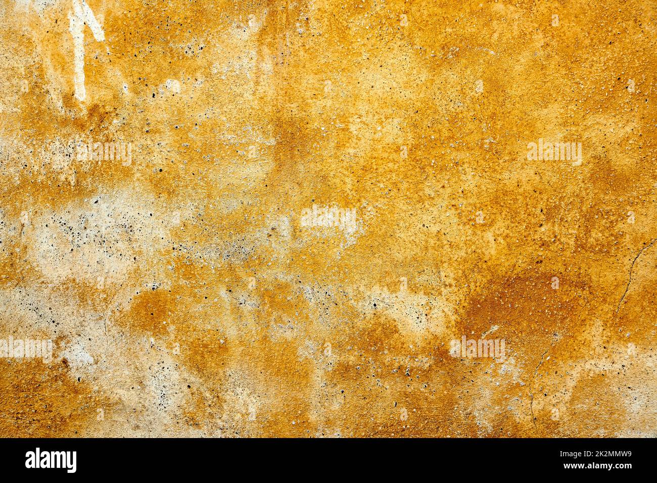 yellow weathered paint on a plastered wall Stock Photo