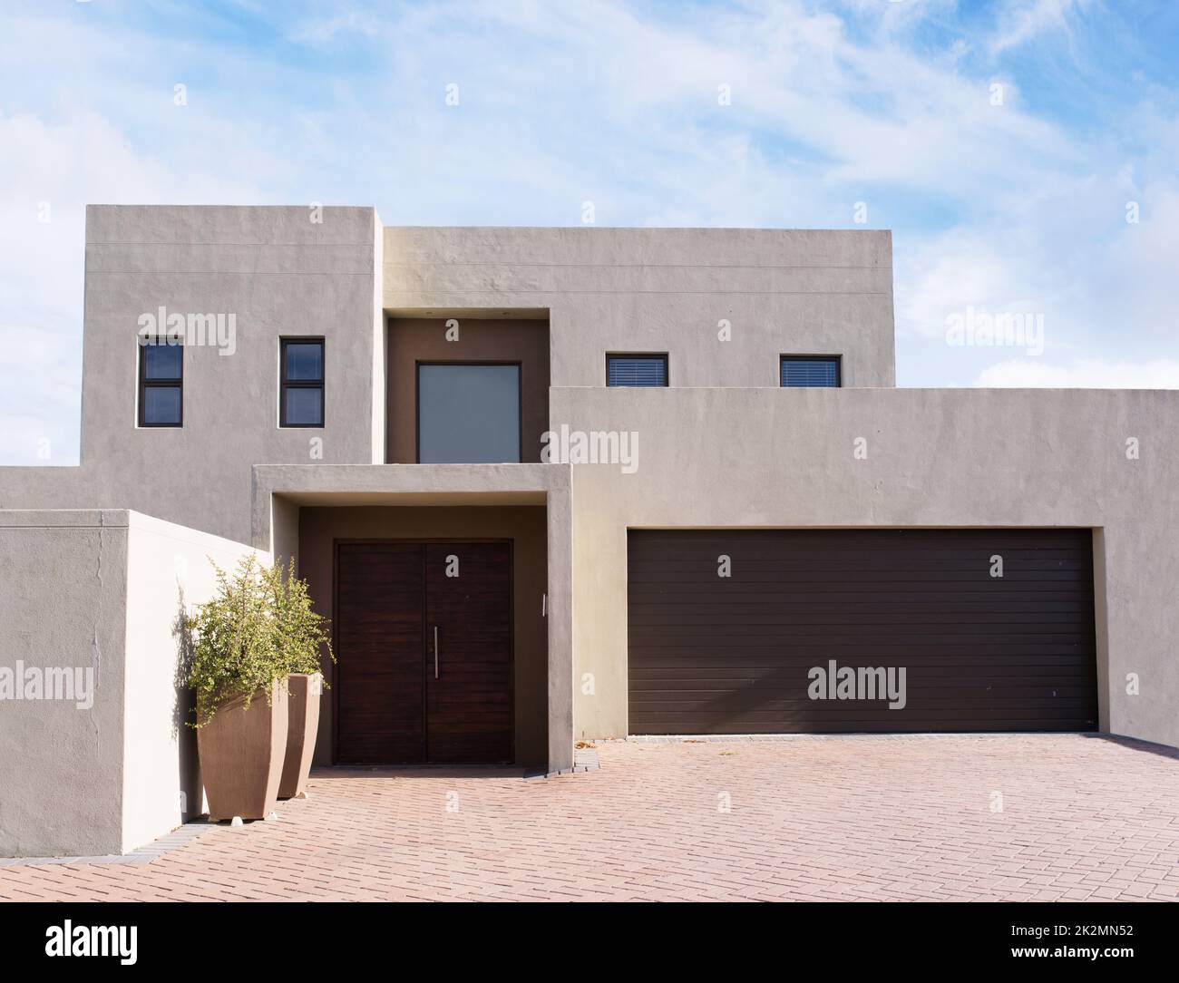 Shot of a modern house in the suburbs - The house designs displayed in this image represent a simulation of a real product and have been changed or altered enough by our team of retouching and design specialists so that they are free of any copyright infr Stock Photo