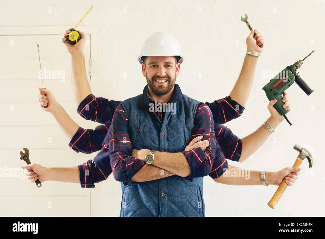 Hes got all the tools youll need. Portrait of a handsome young handyman tools in multiple hands. Stock Photo