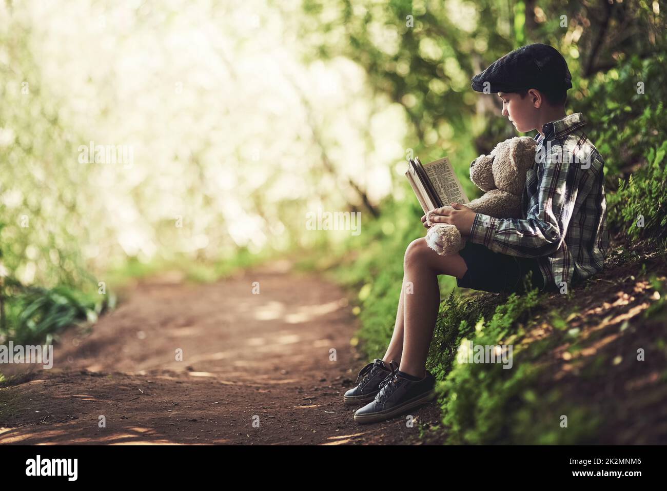 Reading and nature are his two favourite things. Shot of a happy young