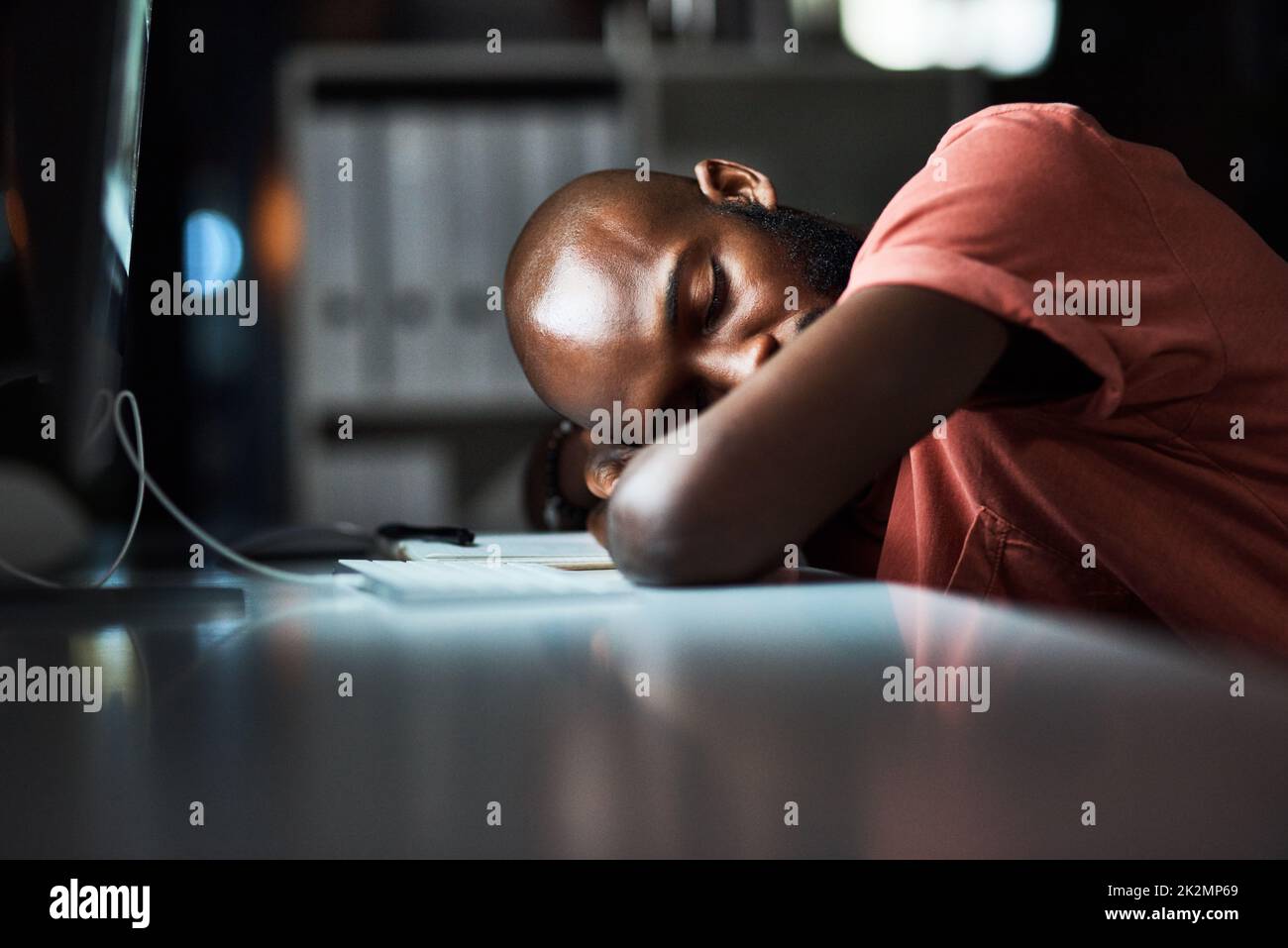 It can be tiring being the hardest worker. Cropped shot of a man falling asleep while working late at the office. Stock Photo