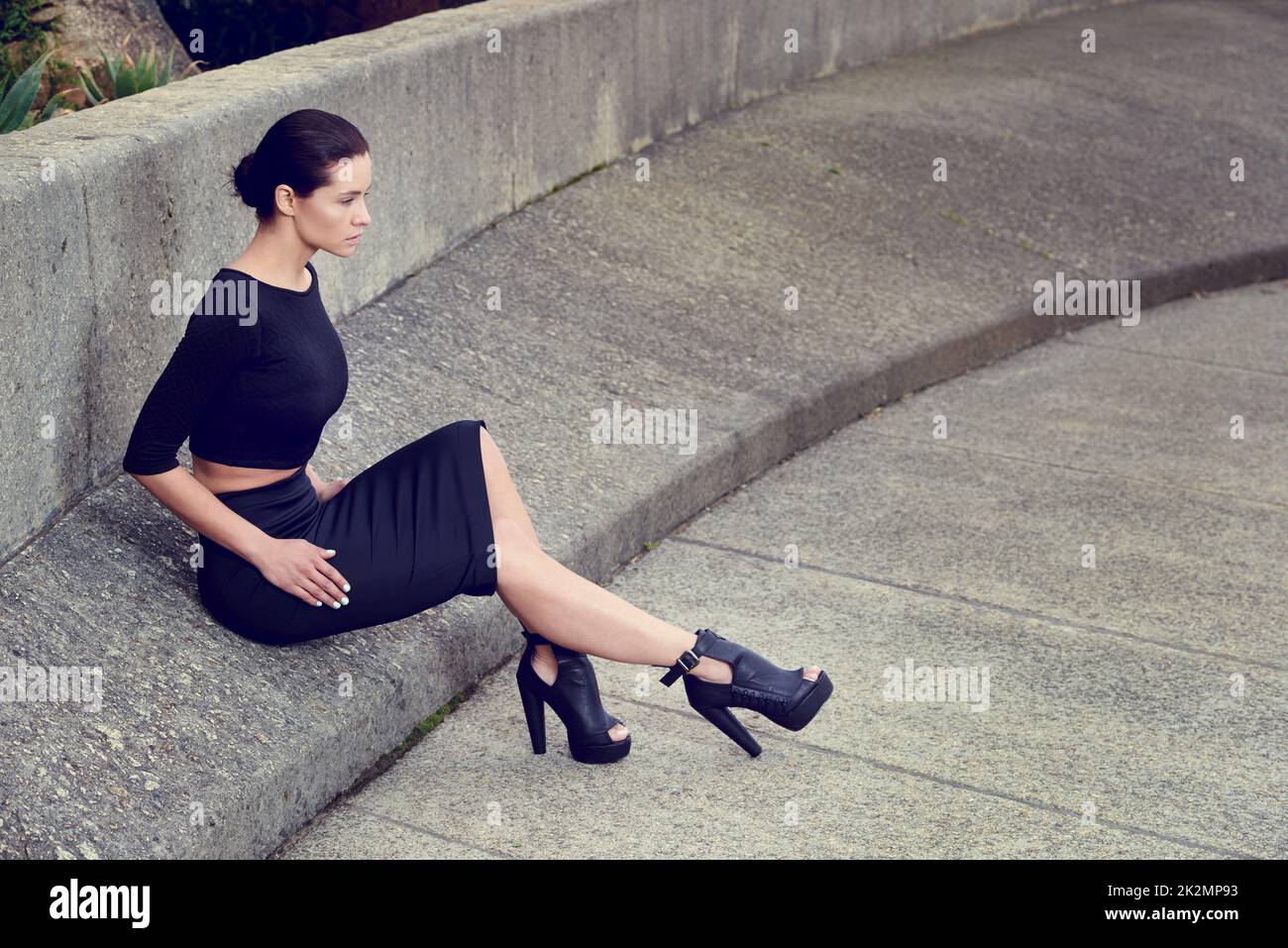 Concrete style. Full length shot of a beautiful fashion model posing in an empty urban setting. Stock Photo