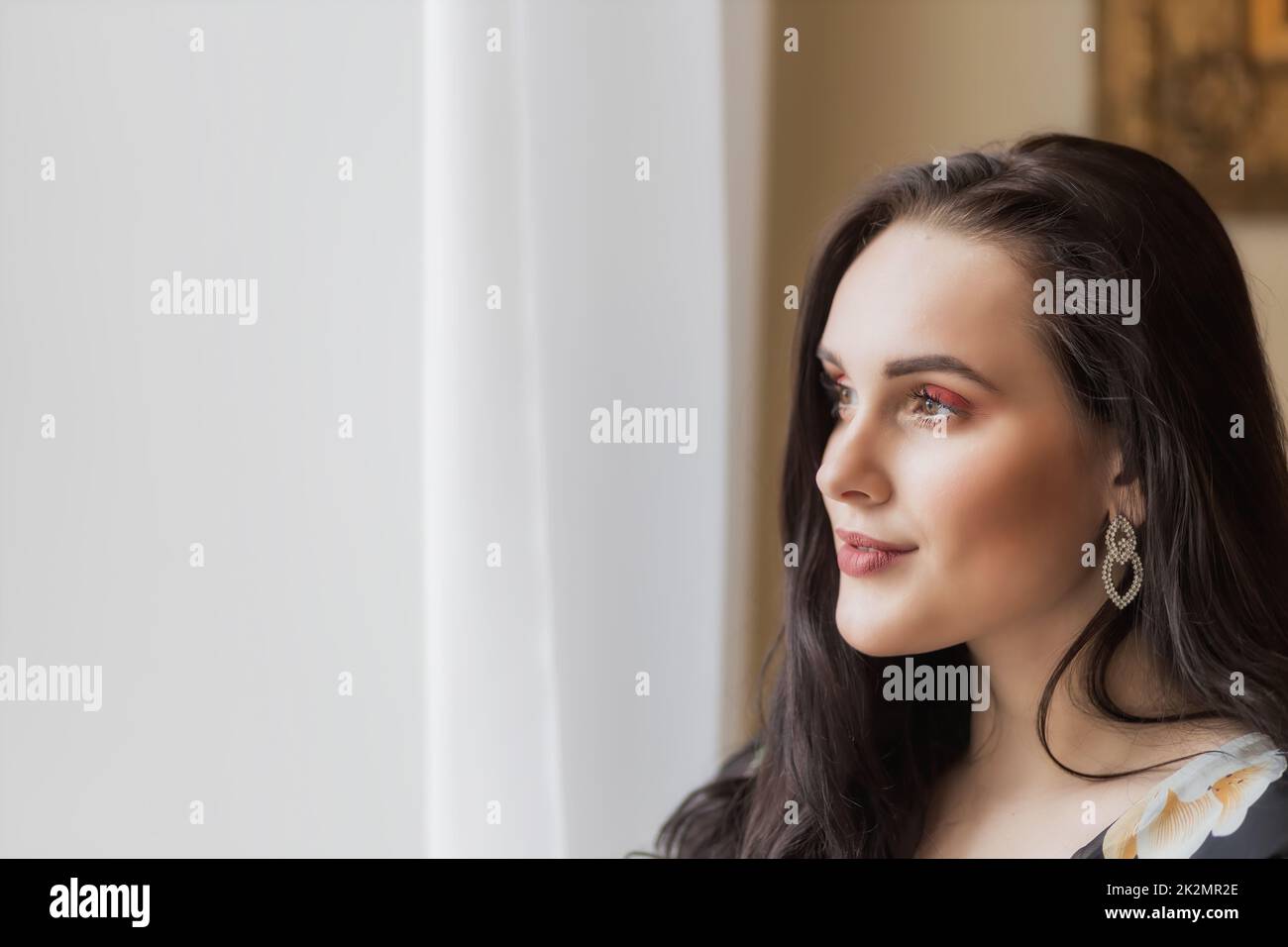 Side view portrait of atractive dark haired young woman. Stock Photo