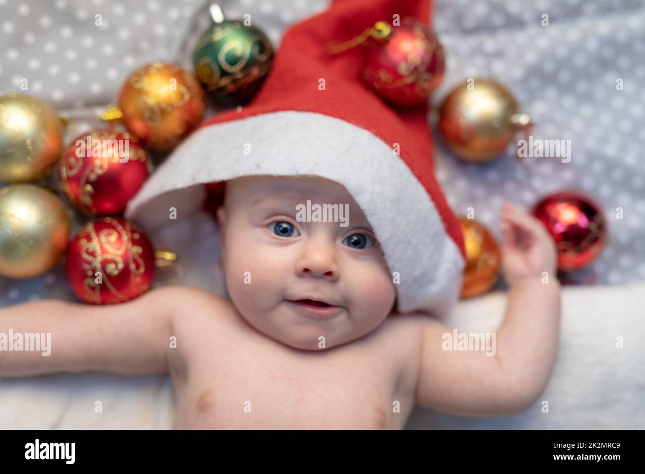 Fun little newborn baby wearing a Santa Claus hat Stock Photo Alamy