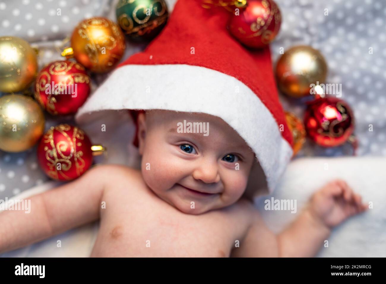 Portrait of baby smiling while wearing a Santa hat Stock Photo