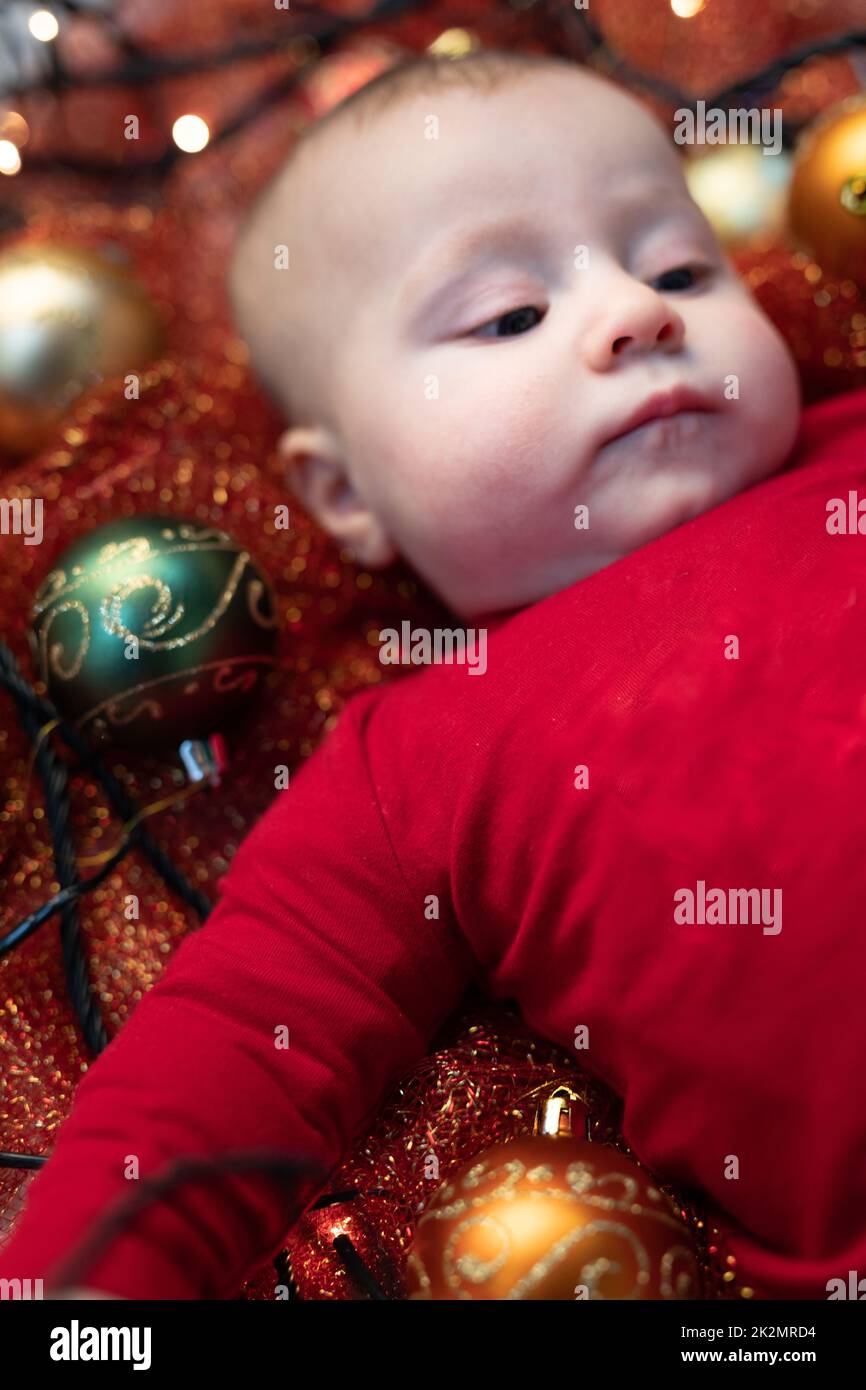 Cute little baby with colorful Christmas baubles Stock Photo