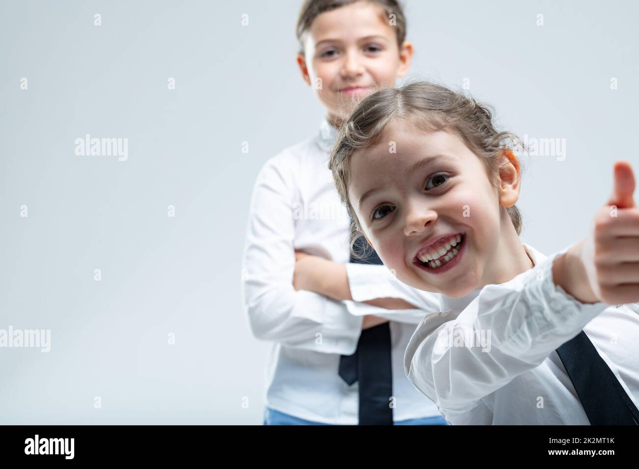 Cheeky enthusiastic little girl giving a thumbs up Stock Photo