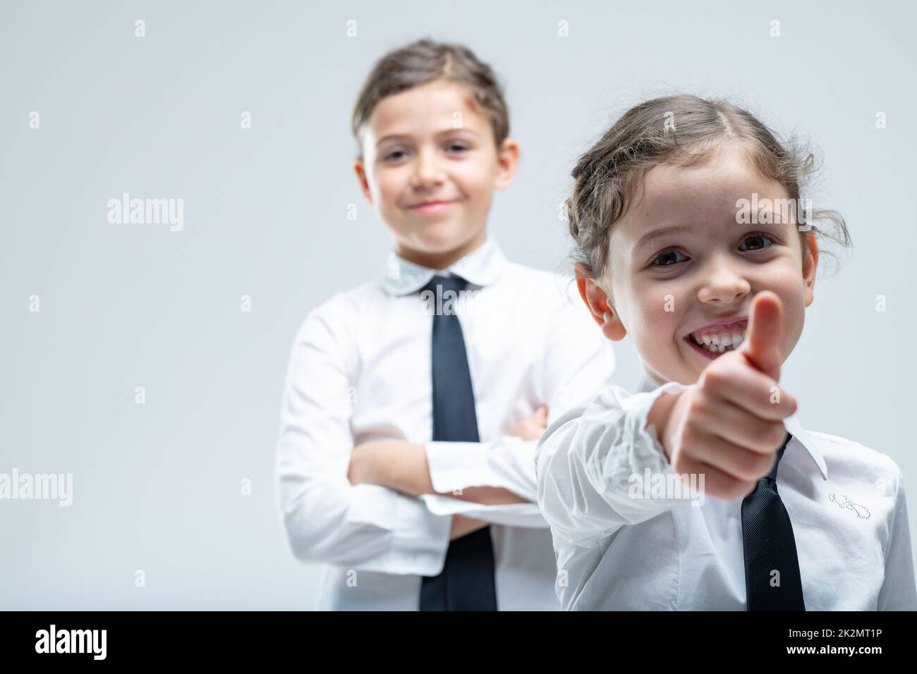 Happy motivated little girl giving a thumbs up Stock Photo