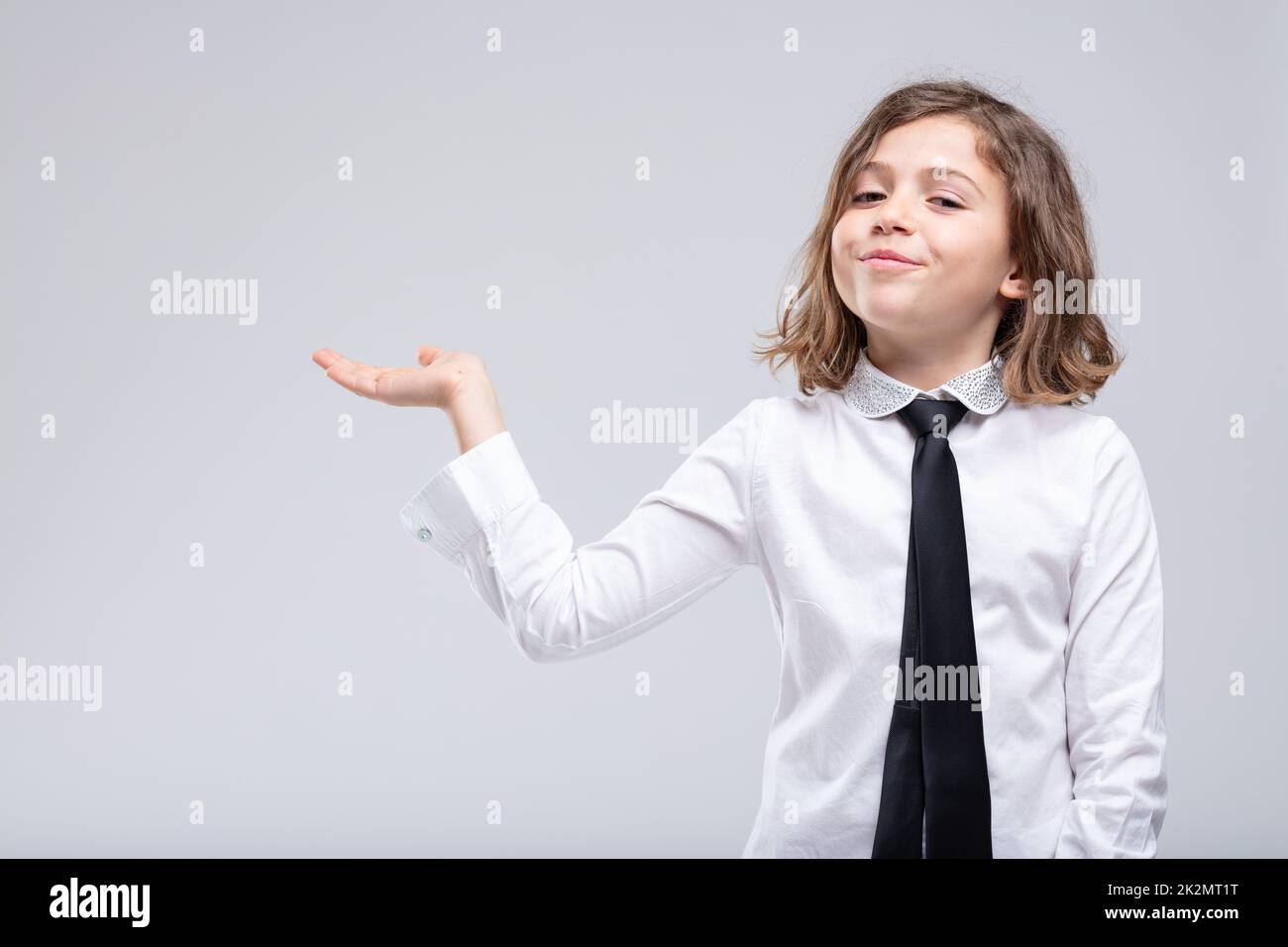 Cute little girl extending her empty palm Stock Photo