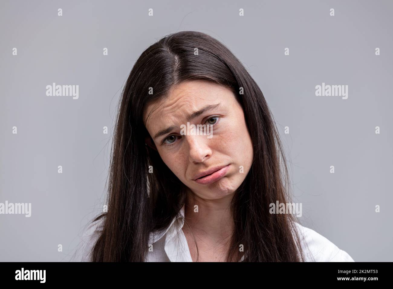 Portrait of young long-haired dejected woman Stock Photo