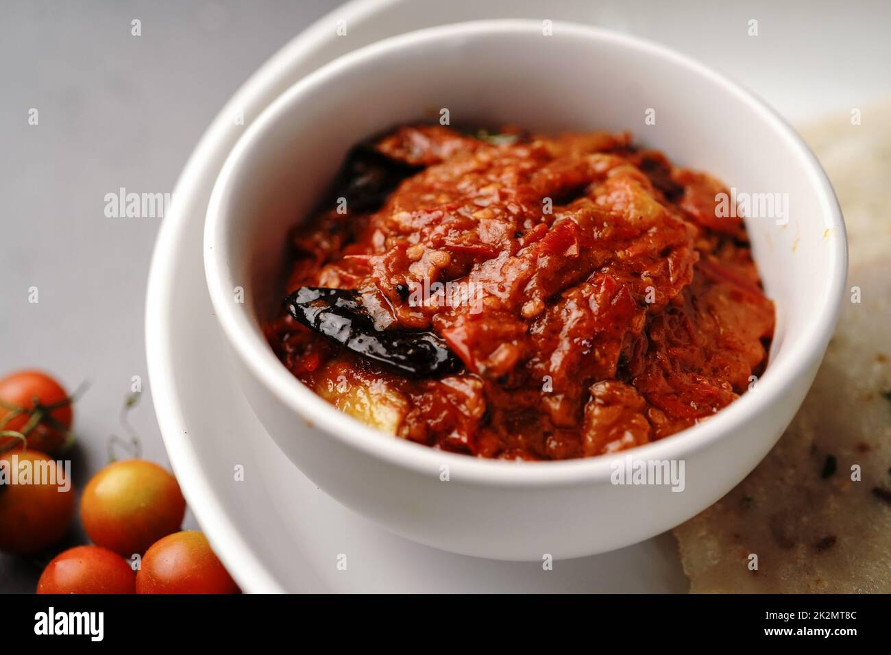 Homemade Tomato pickle Thokku or Chutney served with rice dosa- South Indian breakfast Stock Photo