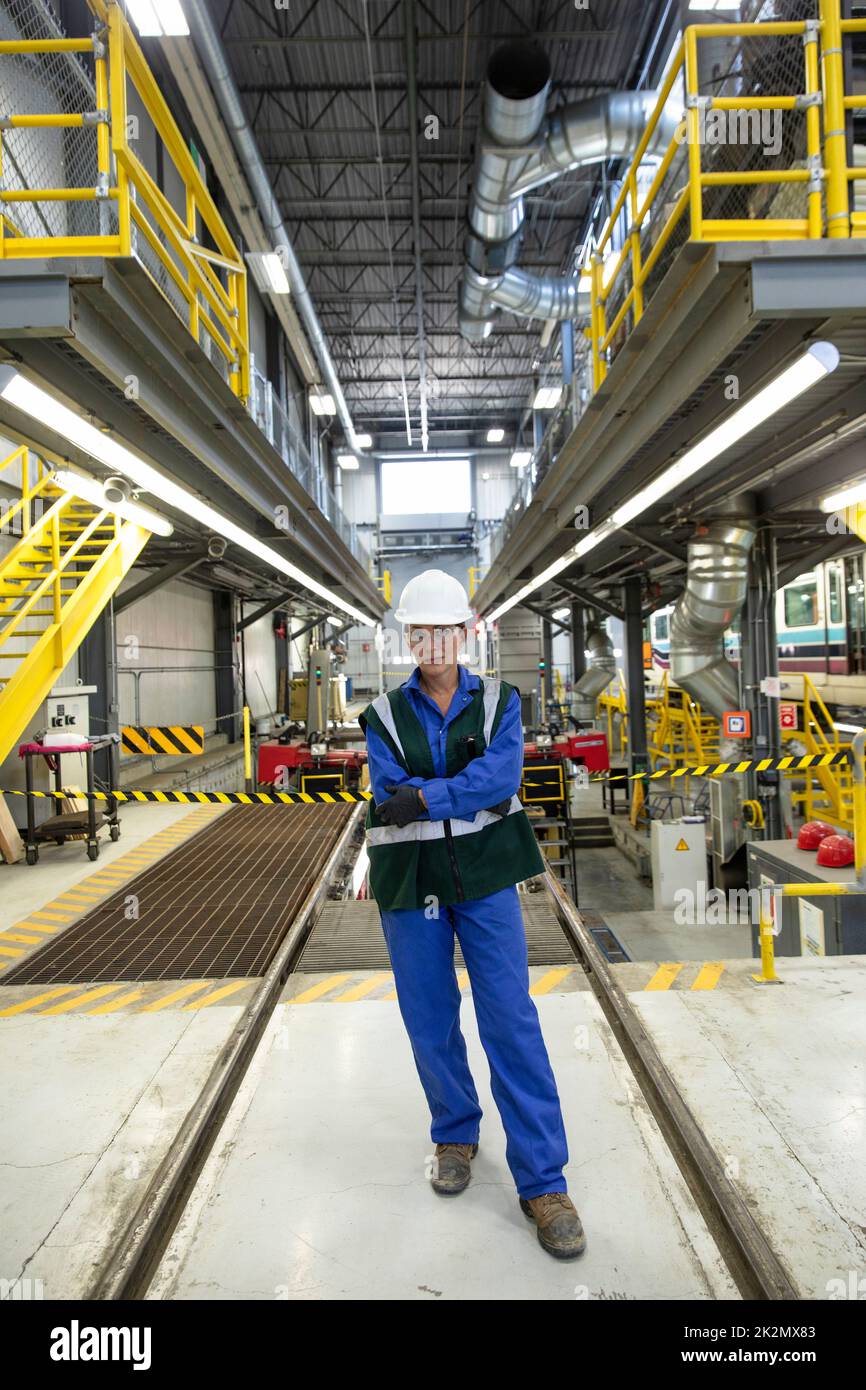 Portrait confident female transit engineer in maintenance facility