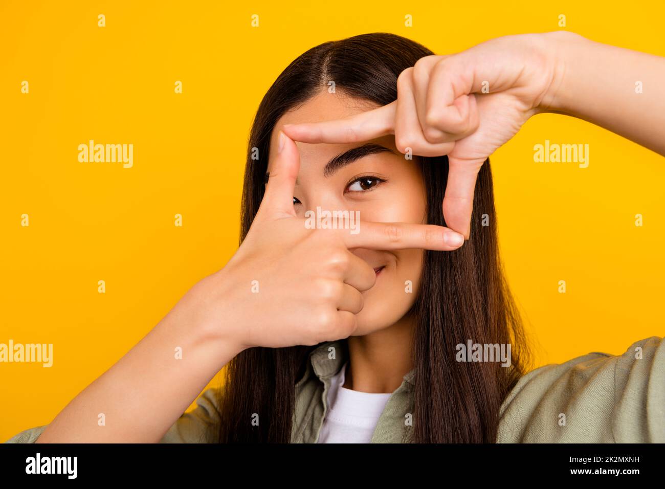 Close up photo of young creative skilled photographer make beautiful pictures isolated on yellow color background Stock Photo