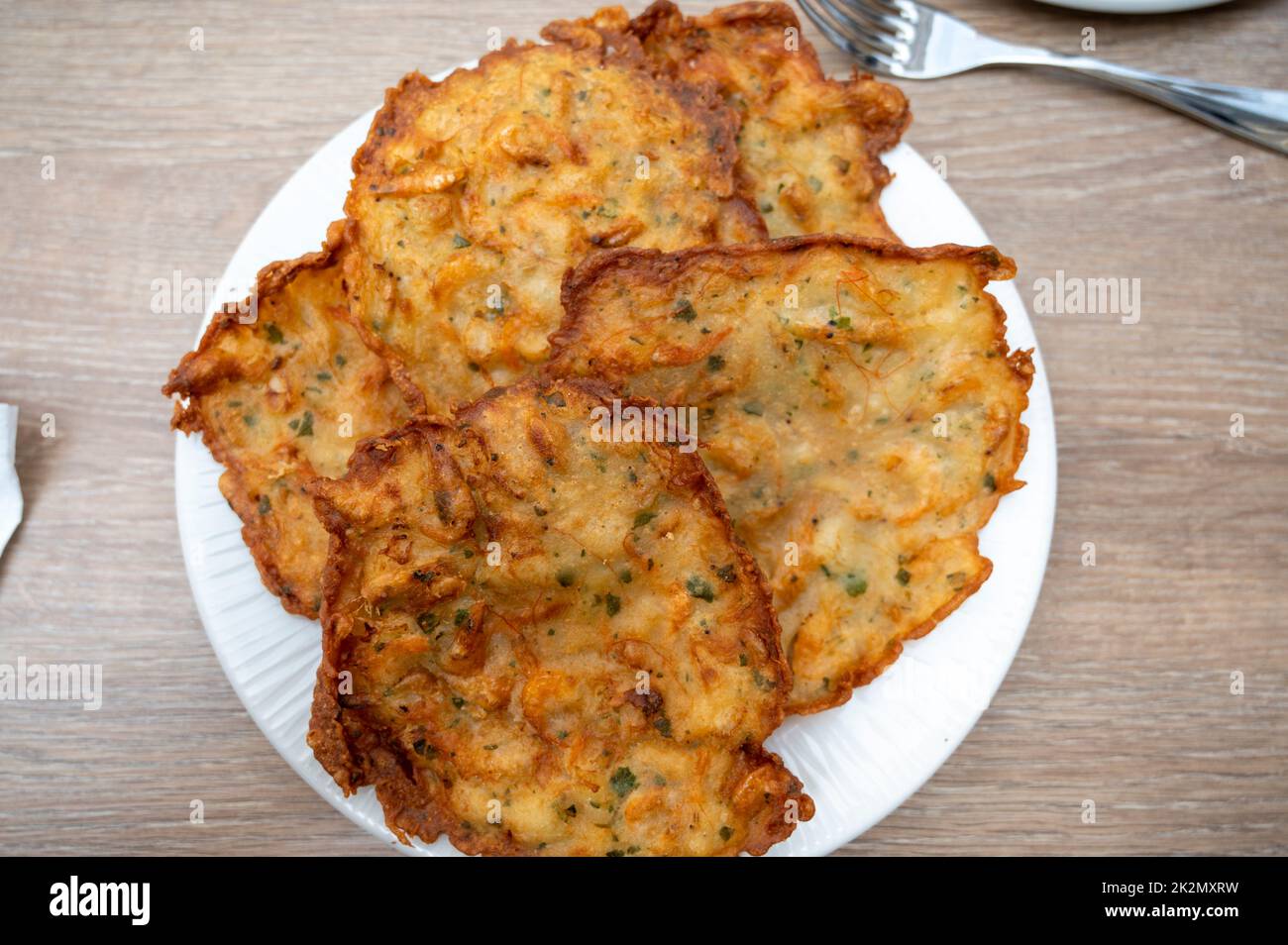 A plate of traditional prawn fritters in a restaurant in Spain Stock Photo