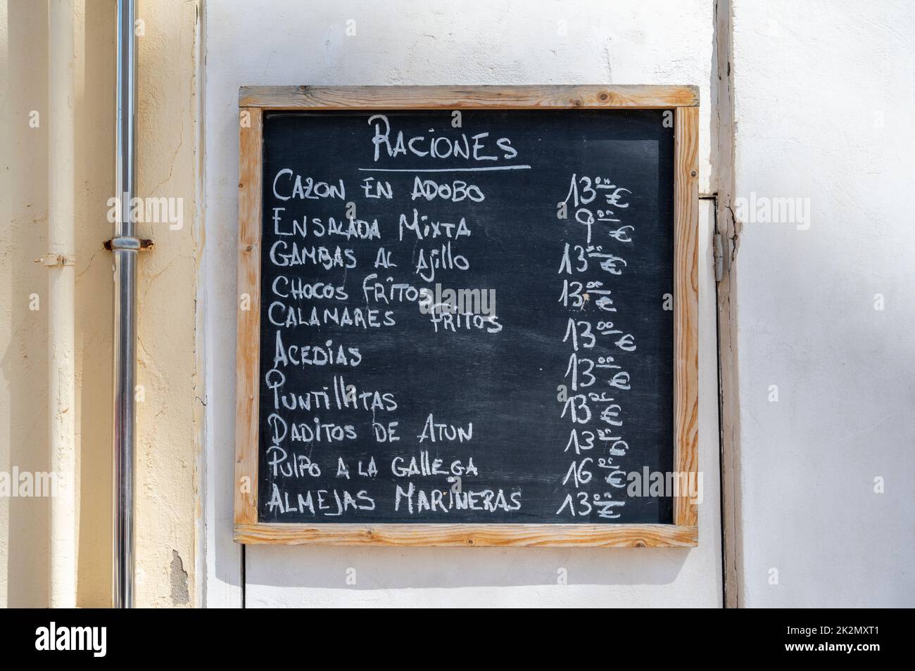 A menu for tapas or raciones on a blackboard outside a restaurant or cafe in Spain Stock Photo
