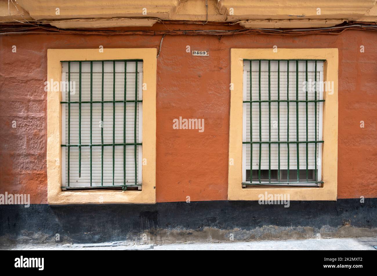 Windows on an old building in the old city of Cadiz Spain with old buildings and cobbed street Stock Photo