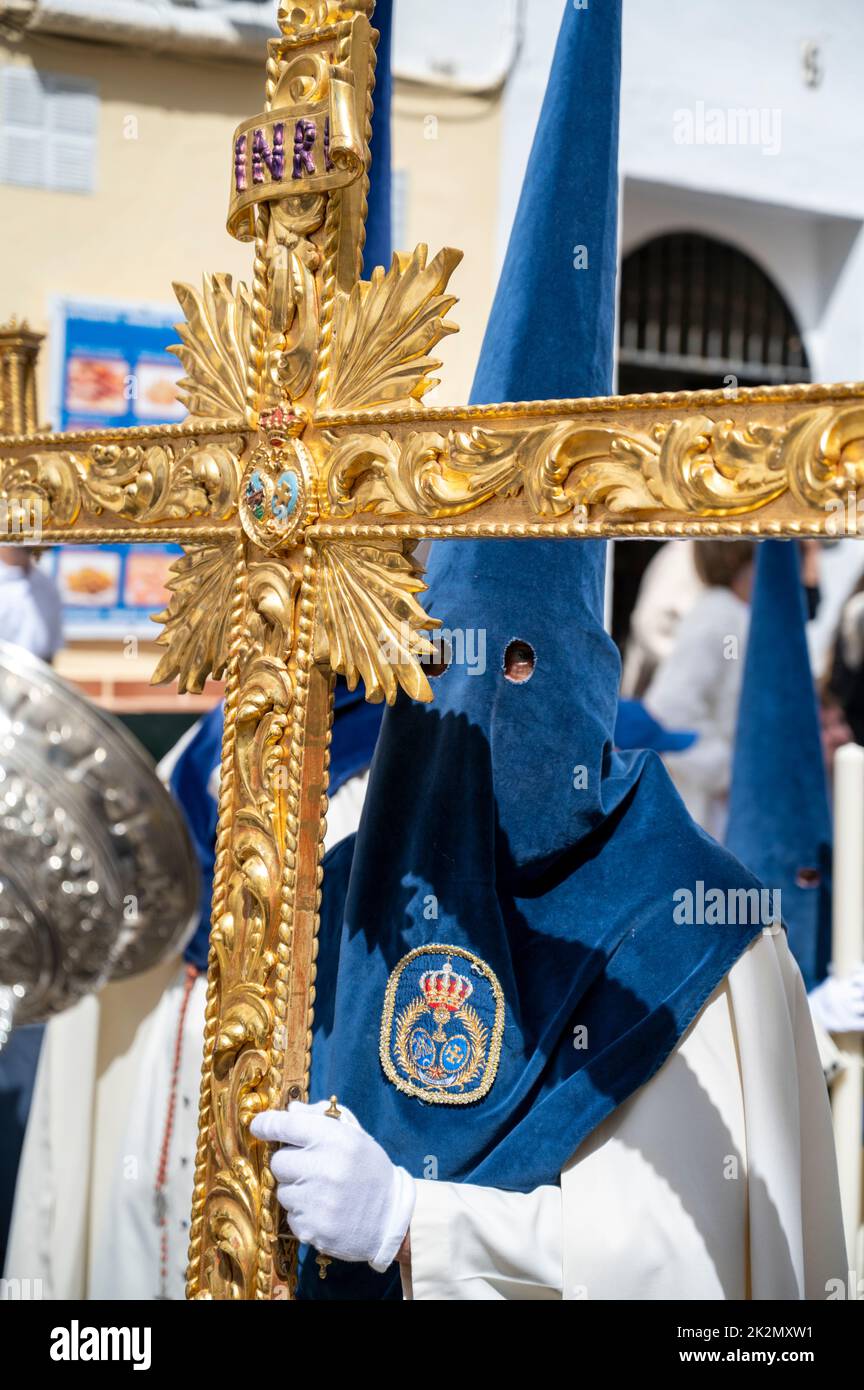 People wearing traditional capirote conical pointed hats in an easter parade in holy week in Cadiz Spain Stock Photo