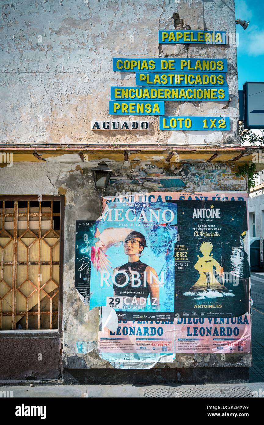 An old building with peeling paint and old posters in Spain Stock Photo