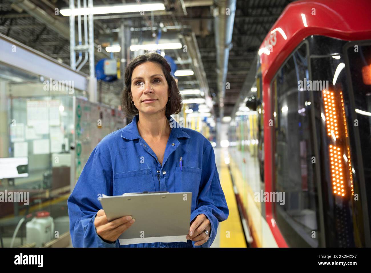 Portrait confident female transit engineer in maintenance facility