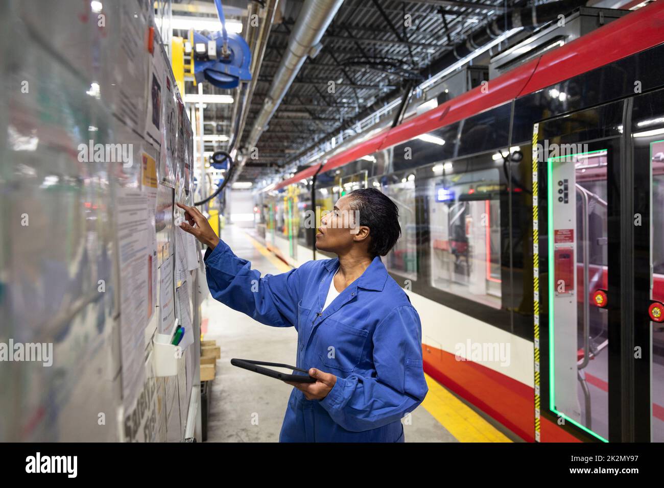Female transit worker at board in maintenance facility Stock Photo Alamy