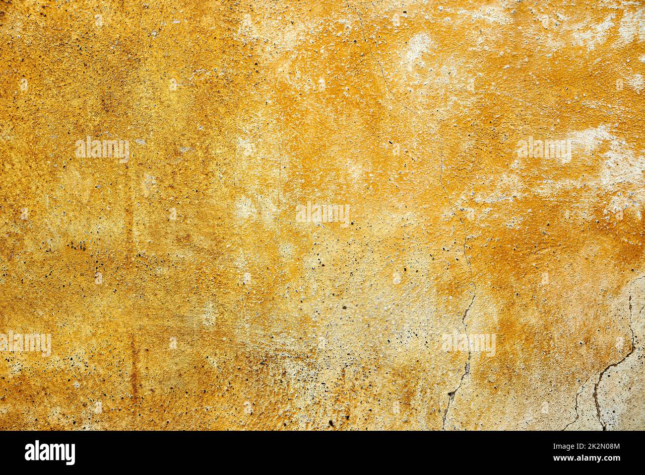 yellow weathered paint on a plastered wall Stock Photo